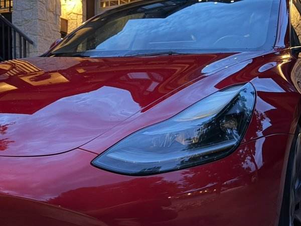 Red Tesla Model 3 with glossy finish
